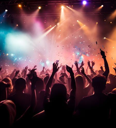 Cheering concert crowd with colorful stage light and confetti, silhouette of Large group of people audience at live music festival